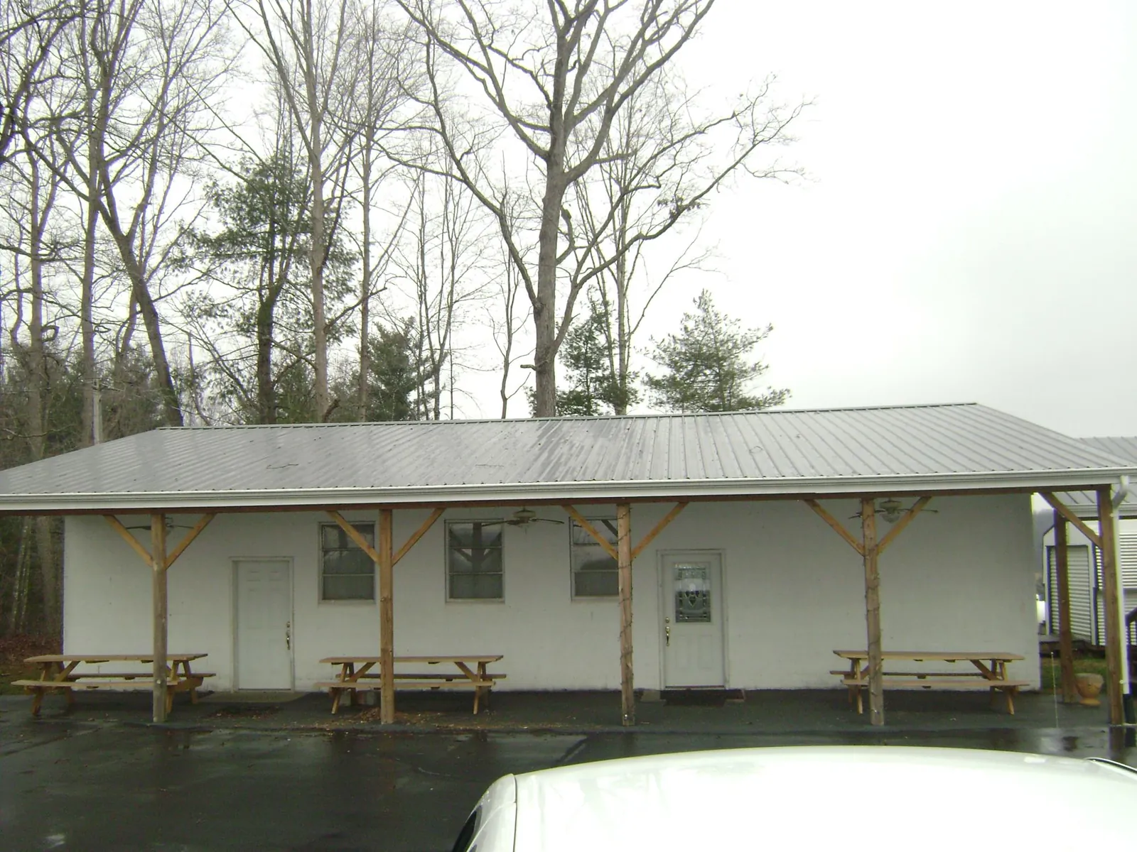 Gray metal roof over a block building with a timber post porch in Eden